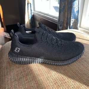 Classy black sneakers with subtle sparkle.
